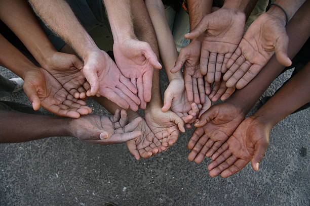 8 Pairs of outstretched hands of many races.