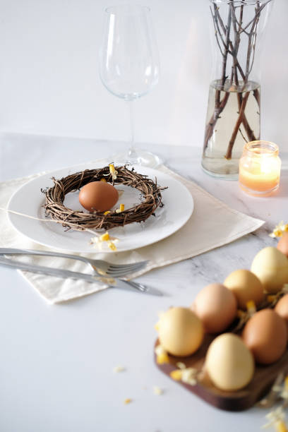 istock Festive Easter table setting with Easter bunny made of linen napkin and yellow egg 1470135977