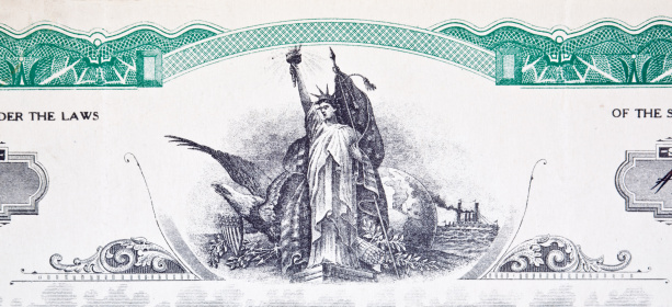 Close up of an old stock certificate vignette showing the Statue of Liberty and a bald eagle.  The term vignette is the term to describe the engraved image on a stock certificate.  - See lightbox for more