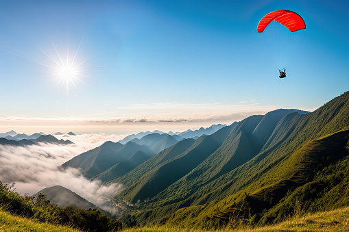 The paraglider soars effortlessly over the mountain range, taking in the breathtaking views of the rugged landscape. The thrill of adventure, the freedom of flight, and the adrenaline rush of being high above the ground all come together in this stunning photo. The vastness of nature is on full display, reminding us of the beauty and majesty of the world around us. It's a truly awe-inspiring moment captured in time.