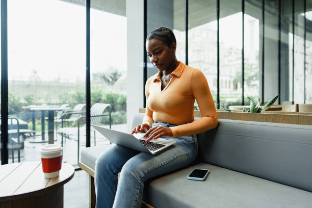 istock African female student working on computer in public place 1470137810
