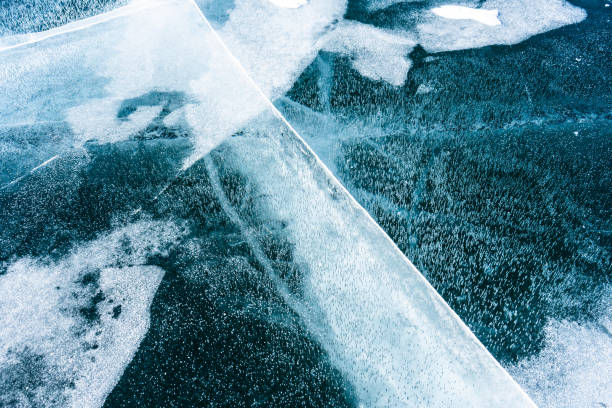 istock Cracked ice on a frozen lake, view from the top. Mouse background. 1470138462