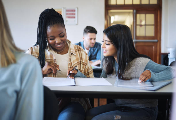 istock Education, teamwork or students in classroom for working together on university, college or school research project. Diversity, smile or happy friends learning, knowledge study or writing in notebook 1470139610