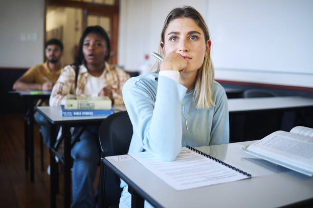 istock University woman, education class and lecture listening with a student ready to take notes for exam. Learning, studying and classroom working of students in college hearing school test information 1470139617