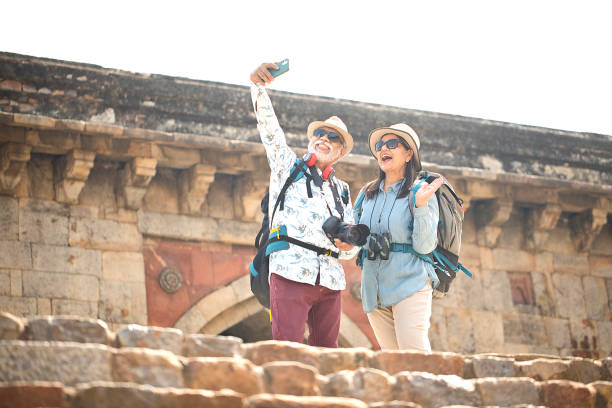 Old couple taking selfie during vacation