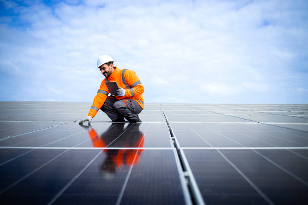 istock Engineer inspector holding digital tablet and working in solar panels power plant checking photovoltaic cells and electricity production. 1470143717