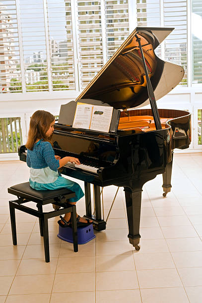 little girl playing the grand piano