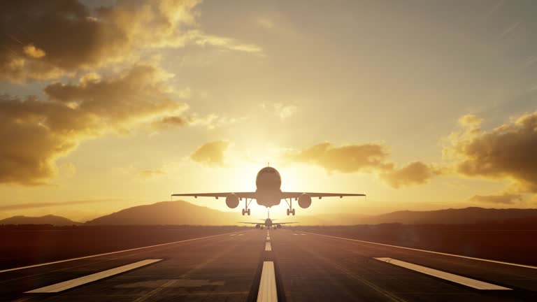 Two airplanes taking off over the runway one by one against the romantic sunset sky for a travel concept