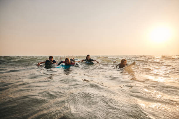 istock Happy surfers having fun in summer day at sea. 1470145375
