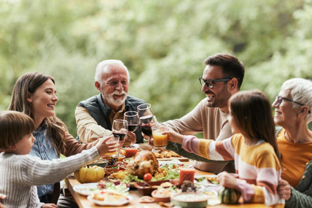 istock Happy multi-generation family toasting during lunch on a terrace. 1470146947