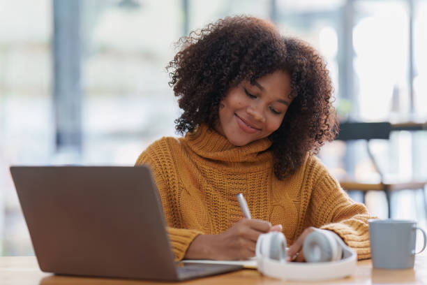 istock Young black African woman university student learning online using laptop computer. Smiling girl watch webinar or virtual education 1470148328