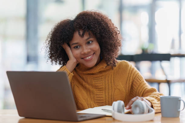 istock Young black African woman university student learning online using laptop computer. Smiling girl watch webinar or virtual education 1470148436