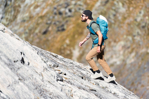 istock Man walks on rocky slope 1470149736