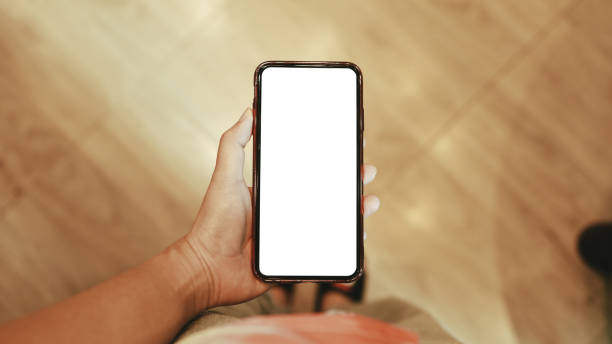 istock Women's hands holding cell telephone blank copy space screen. smartphone with blank white screen isolated on white background . smart phone with technology concept 1470150113