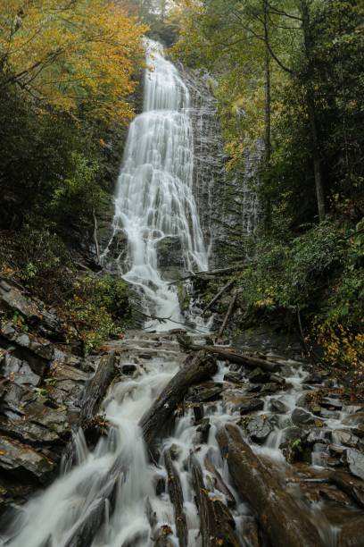 istock Vertical shot of a beautiful waterfall surrounded by rocks in a forest 1470150156