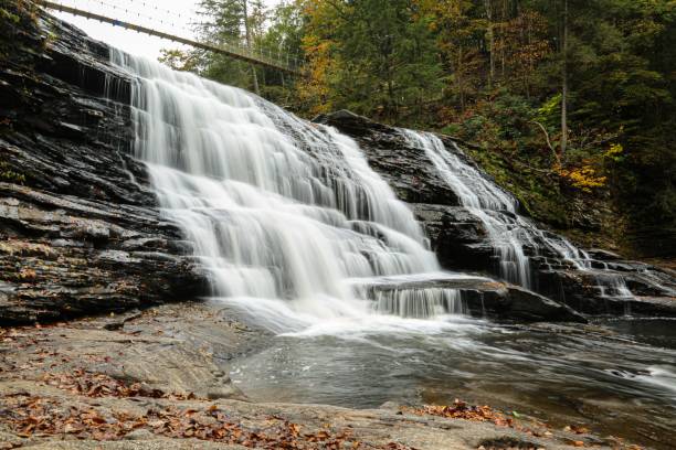 istock Landscape of a beautiful waterfall surrounded by rocks in a forest 1470150174
