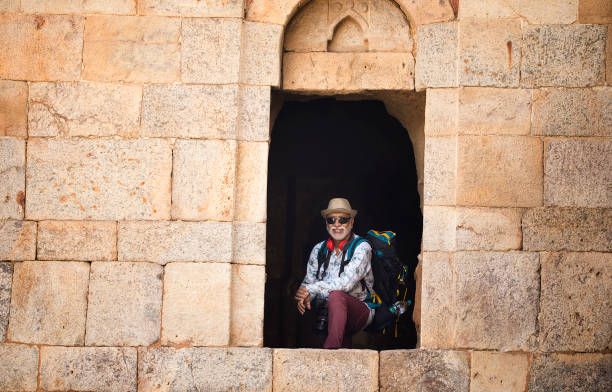 istock Old male tourist posing from the window of ancient structure 1470150981