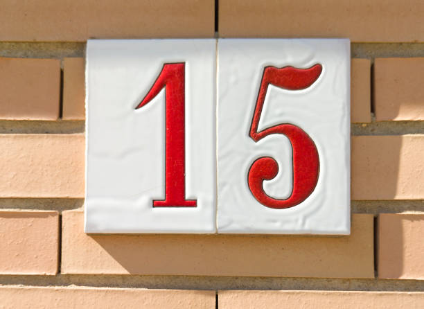 istock House number 15 over brick sunny wall 1470153990