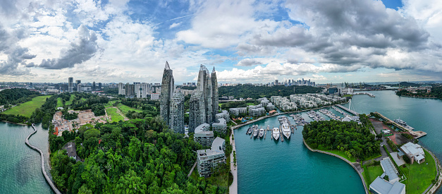 The Keppel Bay area in Singapore is a modern, luxury residential district full of skyscrapers, big yachts in the marina and tropical rainforest.