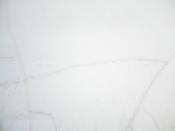 istock The white concrete wall with the long cracked. 1470154867