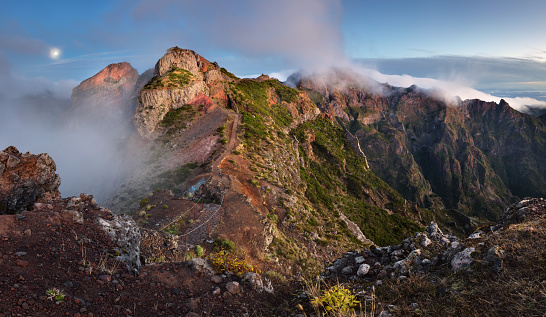 Mountain landscape at sunset in Madeira. Amazing view on colorful clouds and layered mountains.