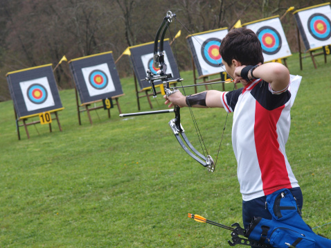 A young boy on a archery competition       