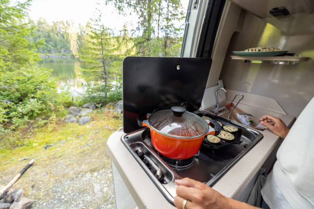istock Woman cooking in her van, lake view 1470157213