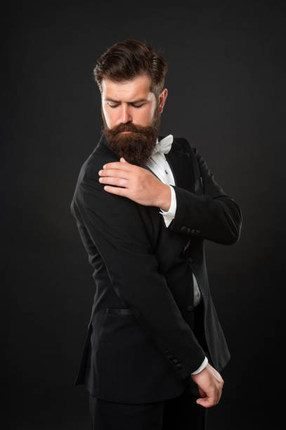 istock elegant butler has dandruff on tuxedo on black background, elegance 1470160497