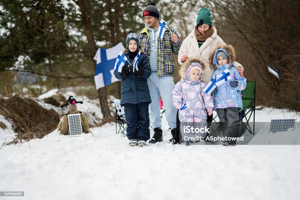 Finnish family with Finland flags on a nice winter day. Nordic Scandinavian people. 2-3 Years Stock Photo