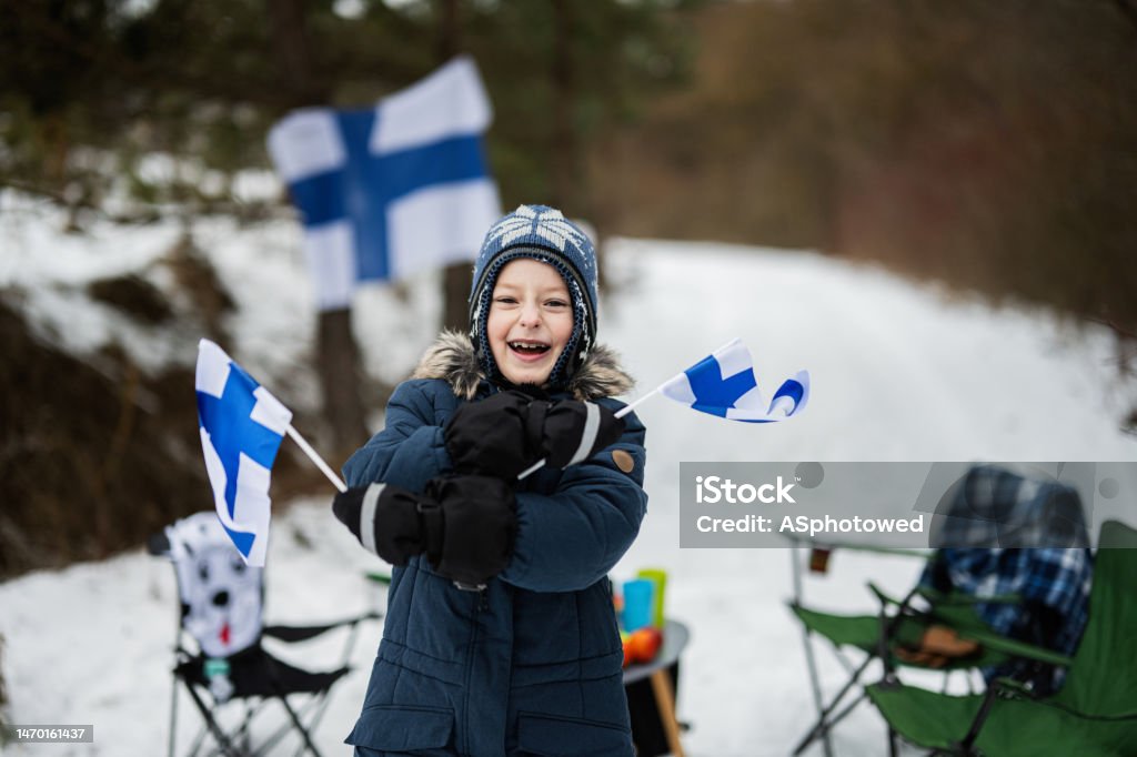 Finnish boy with Finland flags on a nice winter day. Nordic Scandinavian people. Finland Stock Photo