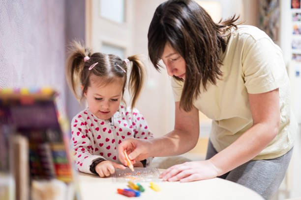 istock Mother and daughter decorating art with glitter decor. 1470161504