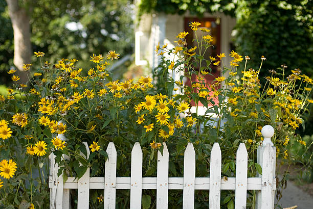 Quaint cottage garden with white fence