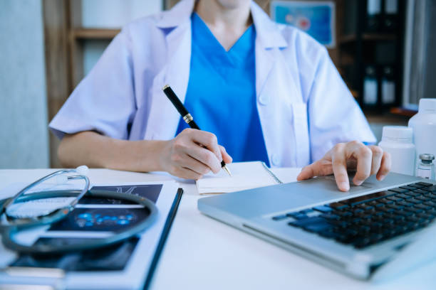 istock Medical technology concept. Doctor working with mobile phone and stethoscope and digital tablet laptop in modern office at hospital in morning light 1470161761