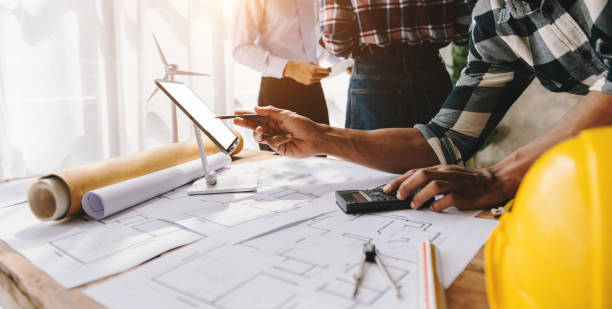 istock Engineer people meeting working in modern office for discussing, engineering .Hands of Engineer working on blueprint Construction concept. 1470161781