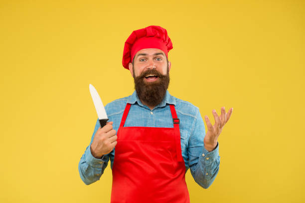 istock Catering by design. excellent cook or baker. special offer from chef. chef in restaurant kitchen. mature male chef on yellow backdrop. happy man cooking on kitchen. Professional chef man with knife 1470161921