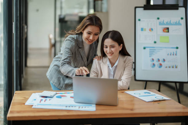 istock Financial analysts analyzing business reports on planned investment projects during corporate meeting discussions showcase successful teamwork with marketing plan, computers and calculators to work 1470162520