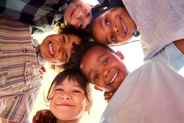 istock Low Angle Portrait Of Smiling Multi-Cultural Children Looking Down Into Camera 1470163109