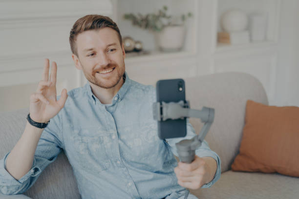 istock Young man talking with his friend through online video chat using telephone 1470164179