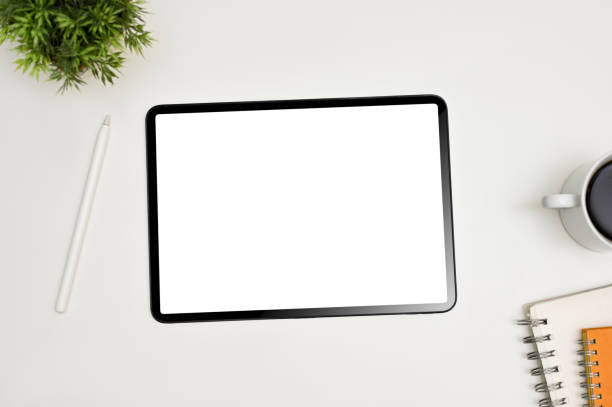 istock Minimal white workspace with digital tablet mockup and decor . top view 1470164185