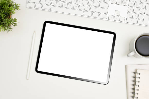istock White workspace top view with keyboard, stylus pen, coffee cup, decor and tablet mockup. 1470164186