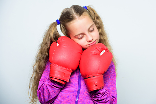 Girl cute child with red gloves posing on white background. Sport upbringing. Upbringing for leader. Strong child boxing. Sport and health concept. Boxing sport for female. Skill of successful leader.
