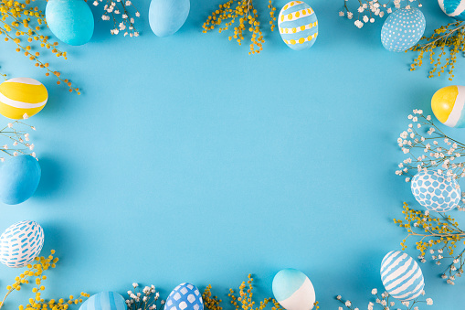 Colorful dyed easter eggs on blue background.