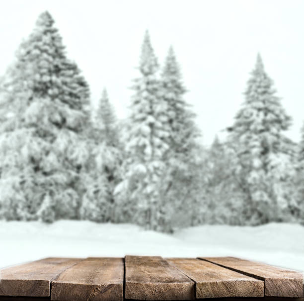istock Wooden desk and snow winter landscape 1470165788