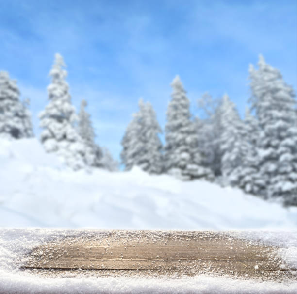 istock Wooden desk and snow winter landscape 1470165802