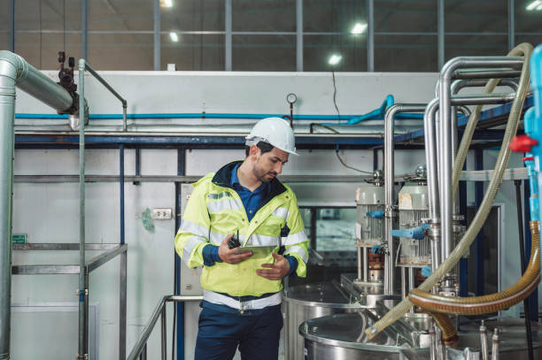 istock Caucasian technician engineer man in uniform with tablet checking and control boiler tanks and liquid pipeline in chemical factory production line 1470165920