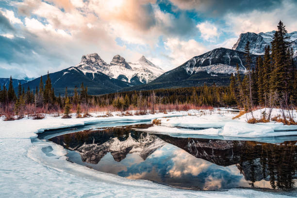 istock Three Sisters Mountains with snow covered on bow river reflection in the morning on winter at Canmore 1470166494