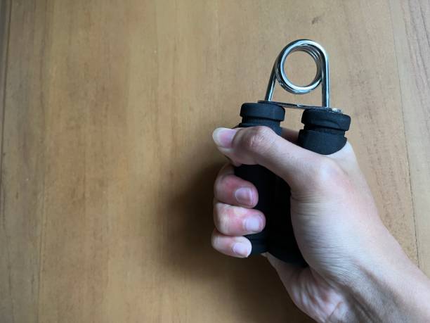 istock Man holding handgrip for exercise with wood background 1470167296