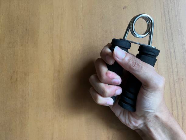 istock Man holding handgrip for exercise with wood background 1470167314