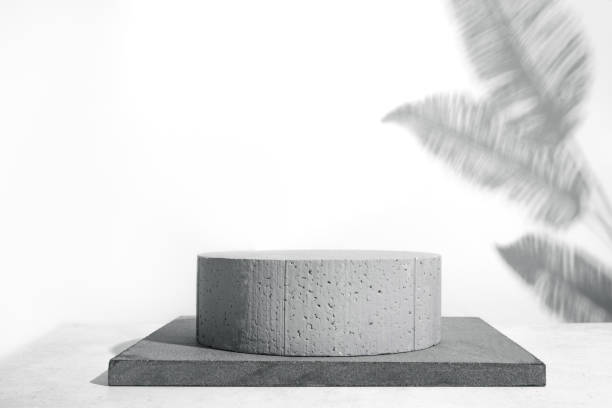 istock Stone podium and palm leaves shadow 1470167770
