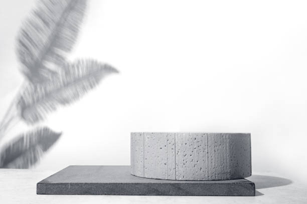 istock Stone podium and palm leaves shadow 1470167780